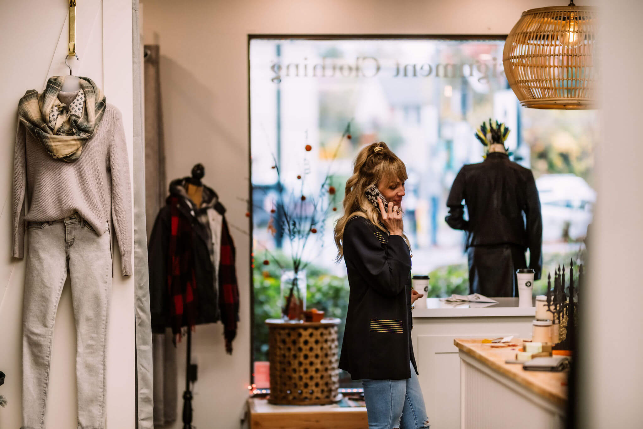 Goldstone Consignment Boutique co-founder Amy Caine on the phone inside Goldstone Boutique